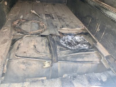 Jeep cargo cut open to reveal Gas tank